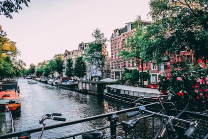 Plan an unforgettable city break in Amsterdam by cycling along the picturesque canals